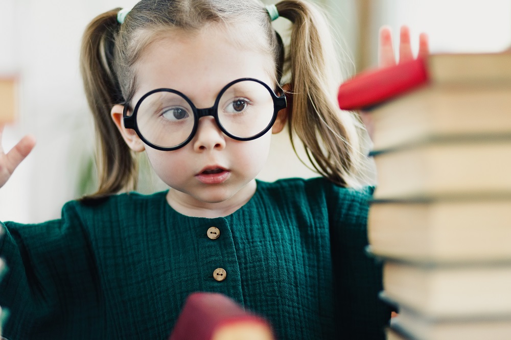 beautiful-little-clever-girl-portrait-round-shaped-glasses-with-books-selective-soft-focus.jpg